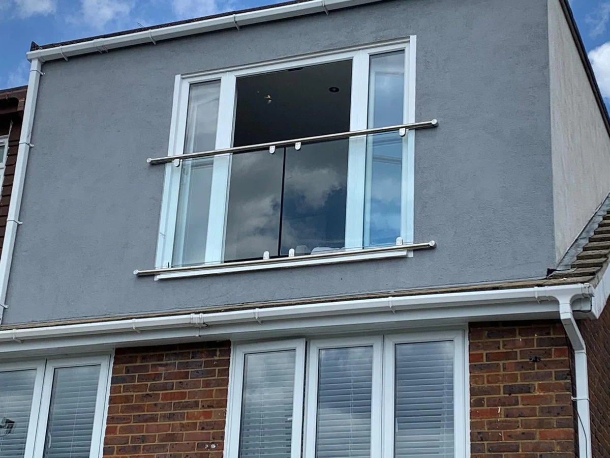 Juliet balcony with steel rails at upper-floor window opening, Farnham Glass Balustrades