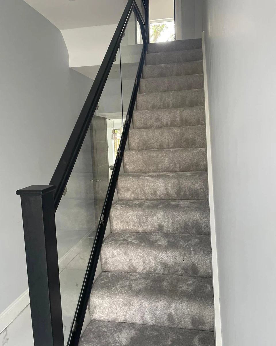 Glass balustrade staircase with black newel posts and grey tones, Farnham Glass Balustrades