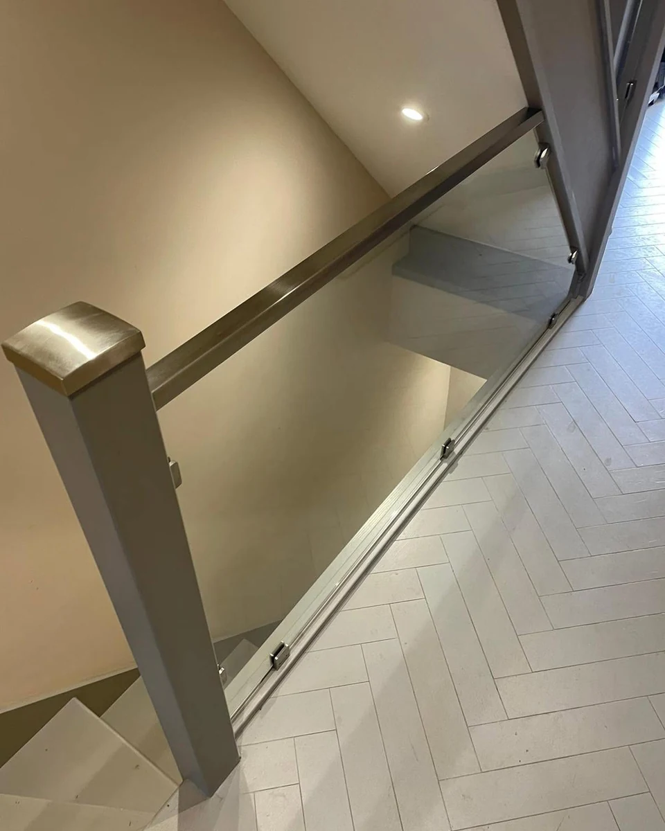 staircase-glass-balustrade-herringbone-landing-farnham-farnham-glass-balustrades Glass balustrade landing installation detail, Farnham Glass Balustrades