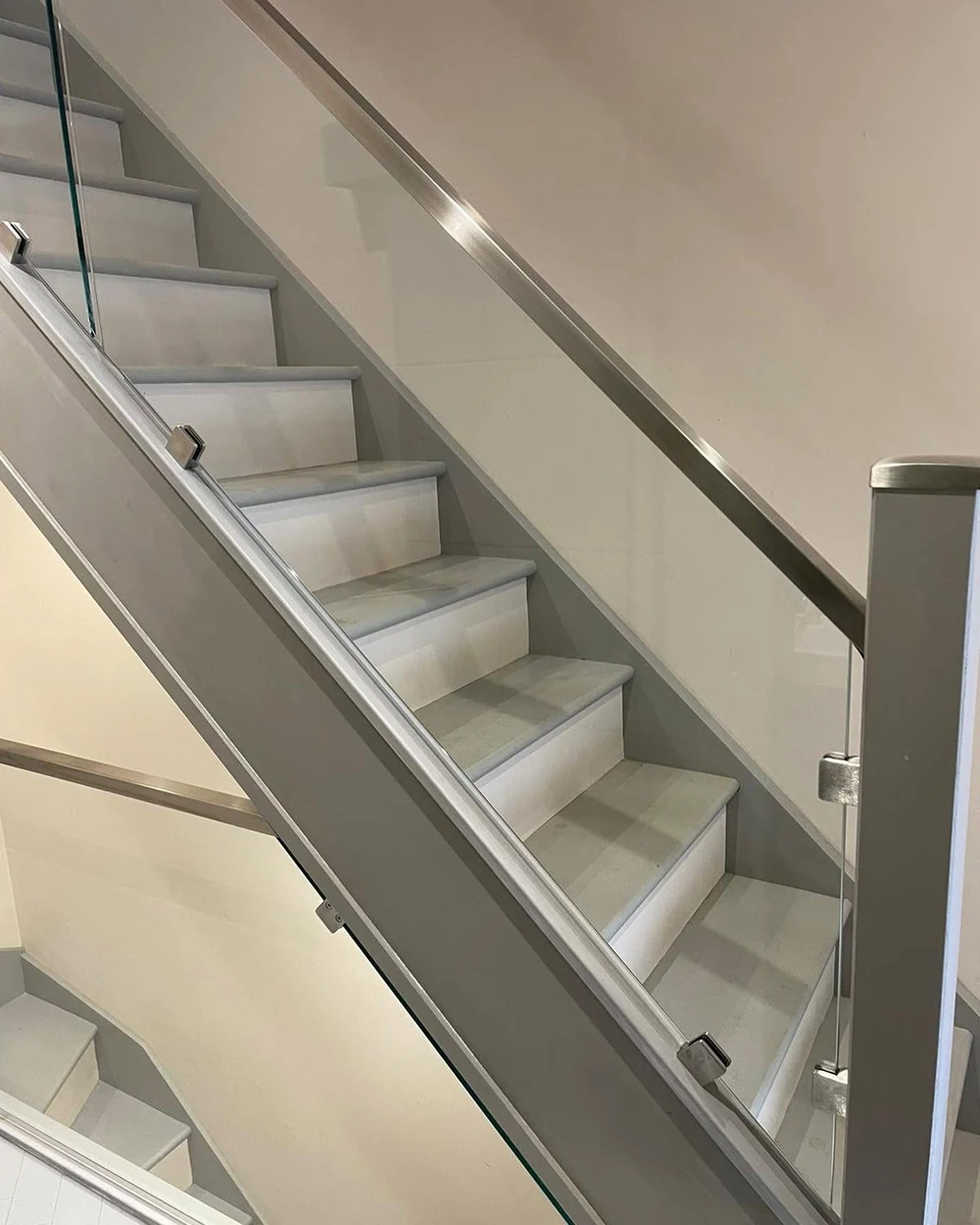 Glass balustrade detail on premium staircase with stone treads, Farnham Glass Balustrades
